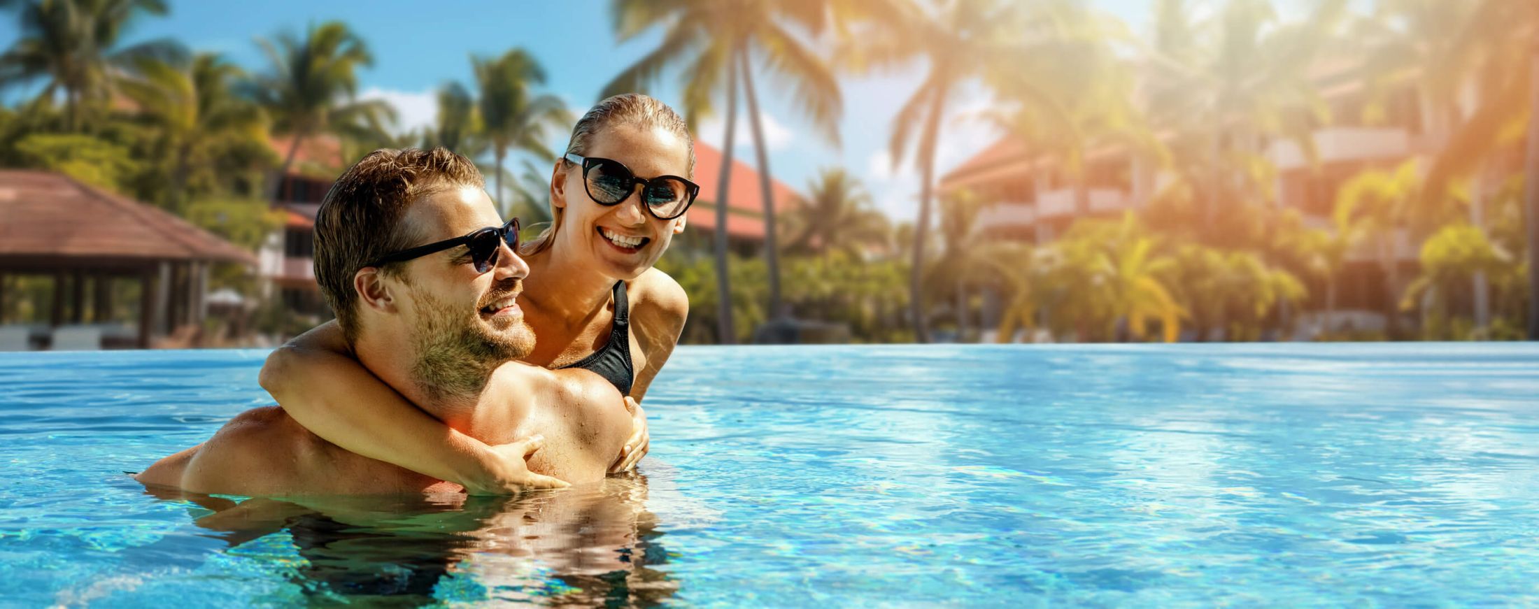 Couple relaxing by a resort pool